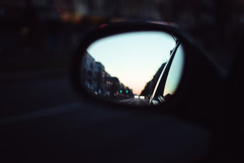 Reflection of City Street in Car Mirror