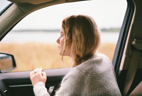 Free Woman in Sweater Inside a Car Stock Photo