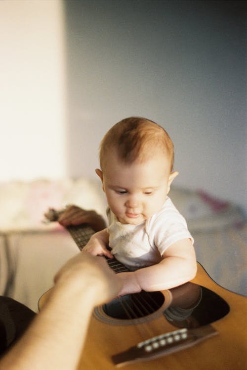 Free Baby Boy Holding a Guitar Stock Photo