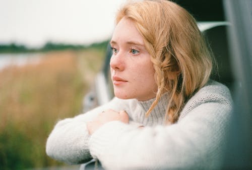 Free Woman in White Sweater thinking Stock Photo