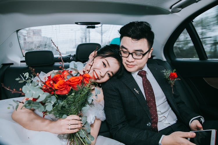 Happy Newlywed Couple In Car