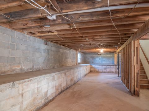 Basement with concrete walls and wooden beams