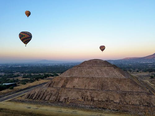 Free Ancient Pyramid of Sun under flying air balloons in Teotihuacan Stock Photo