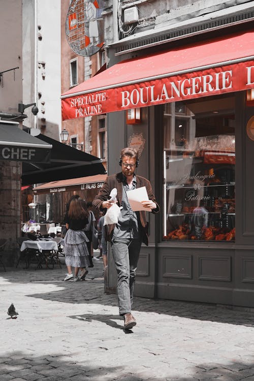Free Man Walking in Front of Bakery Stock Photo