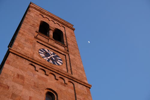 Free Low Angle Shot of a Brown Clock Tower Stock Photo