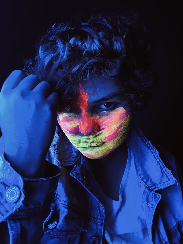 Teen Boy Standing In Neon Light