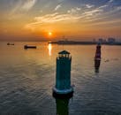 Lighthouse on the Sea During Golden Hour