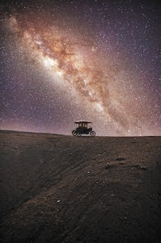 A breathtaking view of the Milky Way arching over a motorcycle at night in Puerto Malabrigo, Peru.