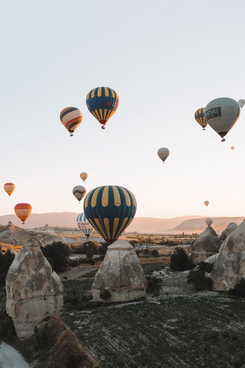 Free Stunning view of colorful hot air balloons soaring over Cappadocia's unique landscape in Turkey. Stock Photo