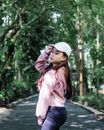 Stylish Asian woman in sunny park