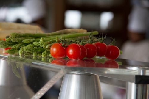Asparagus and Tomatoes on a Glass Table