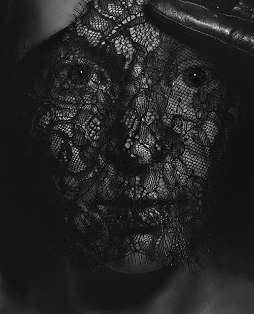 Woman with a Black Lace Fabric on Her Face 