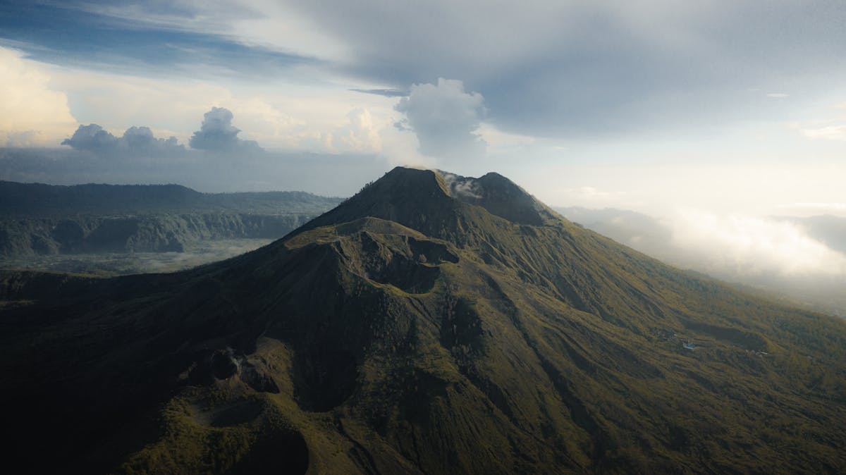 Clouds drifting over the volcanic crater of Mount Batur in Bali at sunrise