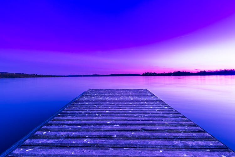 Wooden Pier Above Glowing Purple Lake