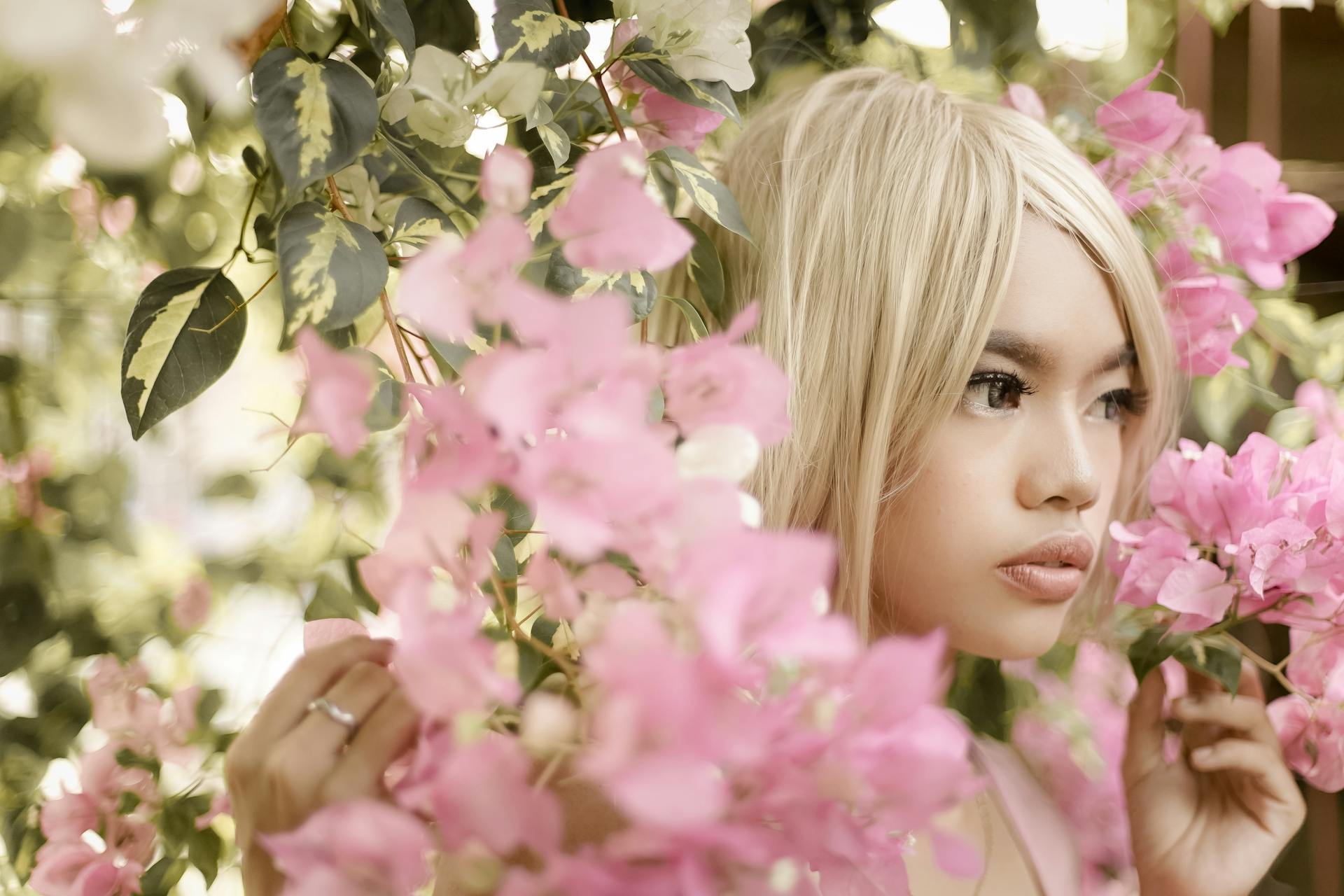 Woman Wearing Blonde Wig Holding Pink Flowers