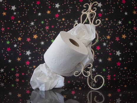A stylish toilet paper roll on a metal stand with a vibrant starry background.