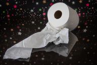 White Toilet Paper Roll on Black and Yellow Floral Textile