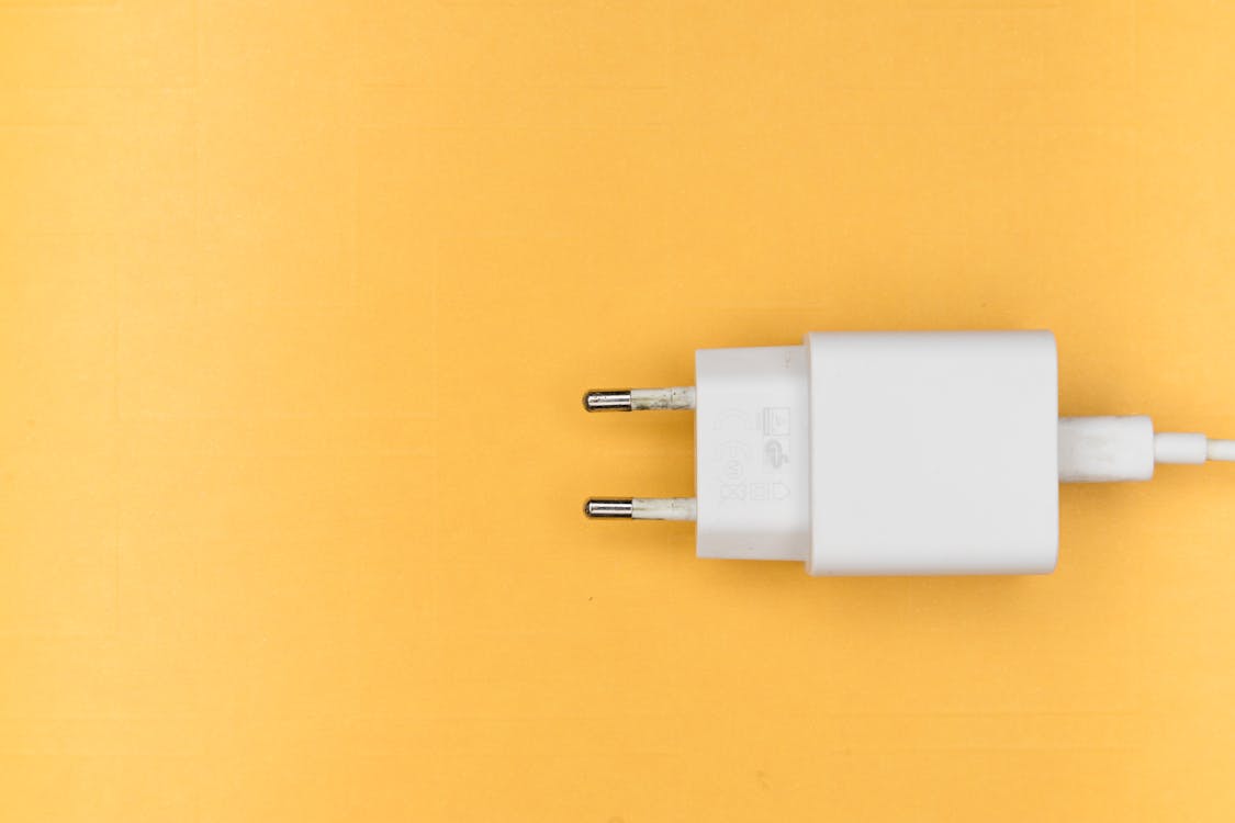 Free Mobile Adapter on Yellow Background Stock Photo