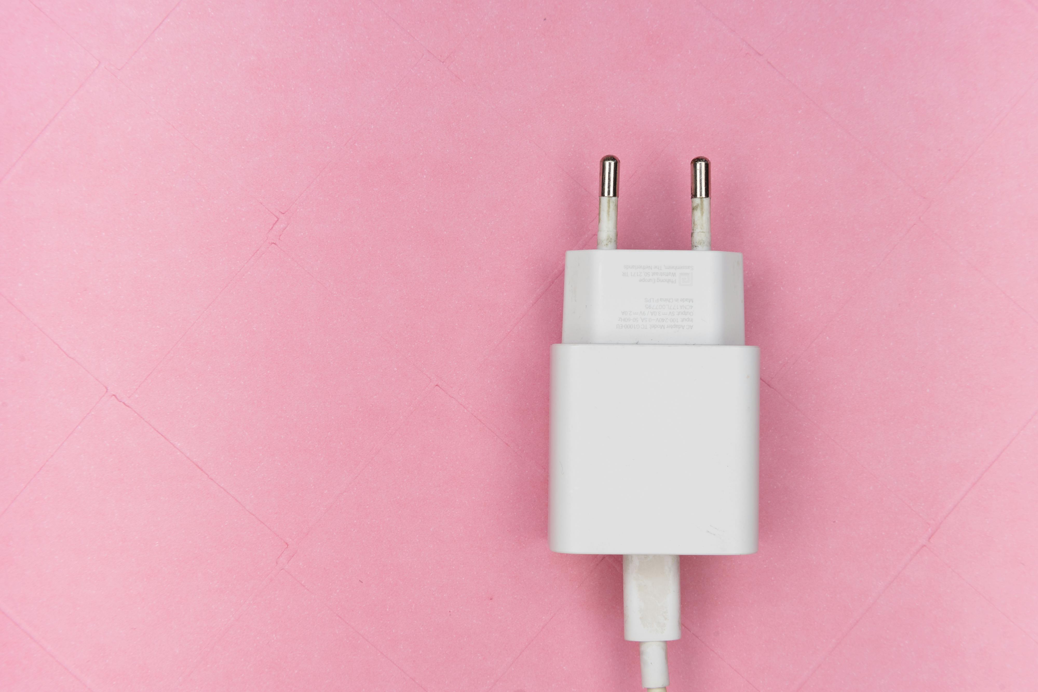 White Adapter on Pink Surface · Free Stock Photo