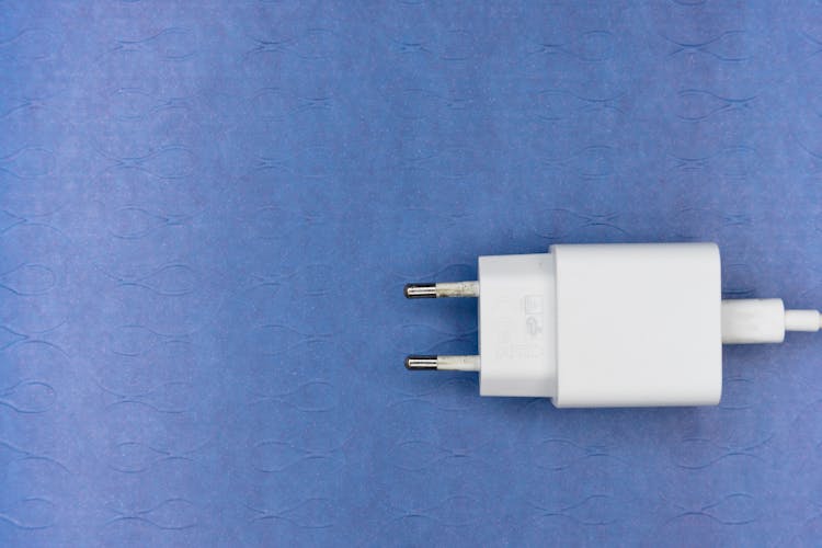 White Adapter On A Blue Surface