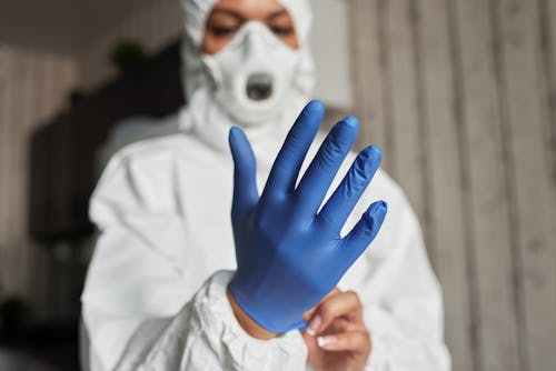 Hand of a Person Wearing a Latex Glove