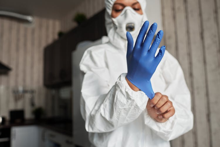 A Hand Of A Person Wearing Latex Glove