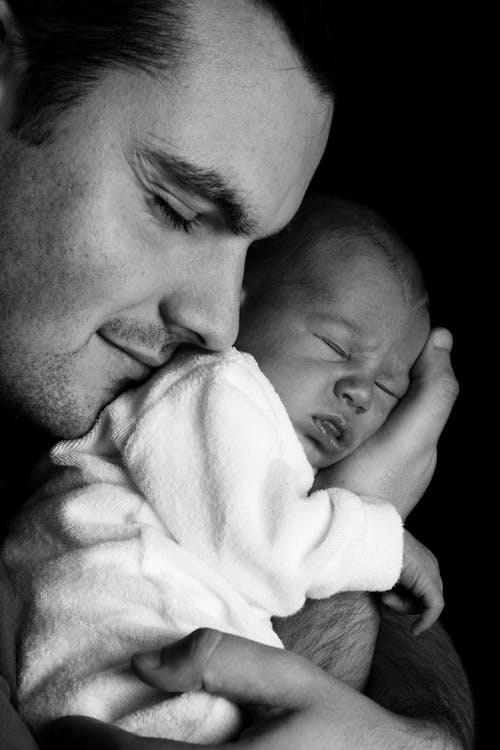 Free Men Carrying a Baby Greyscale Photography Stock Photo