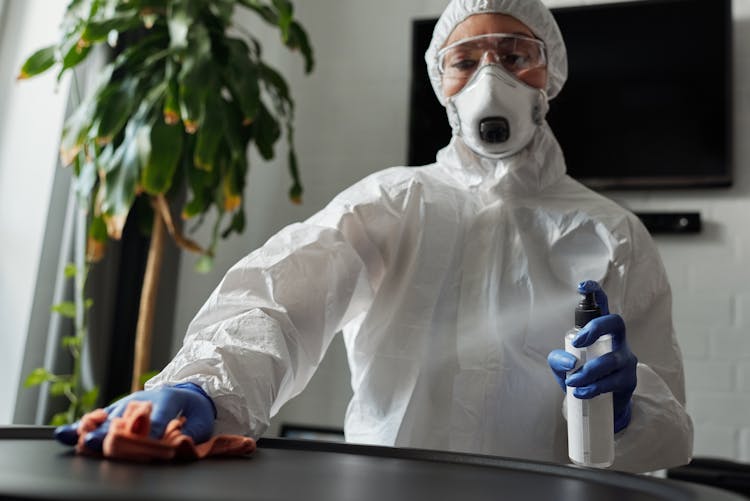 A Person Cleaning The Table