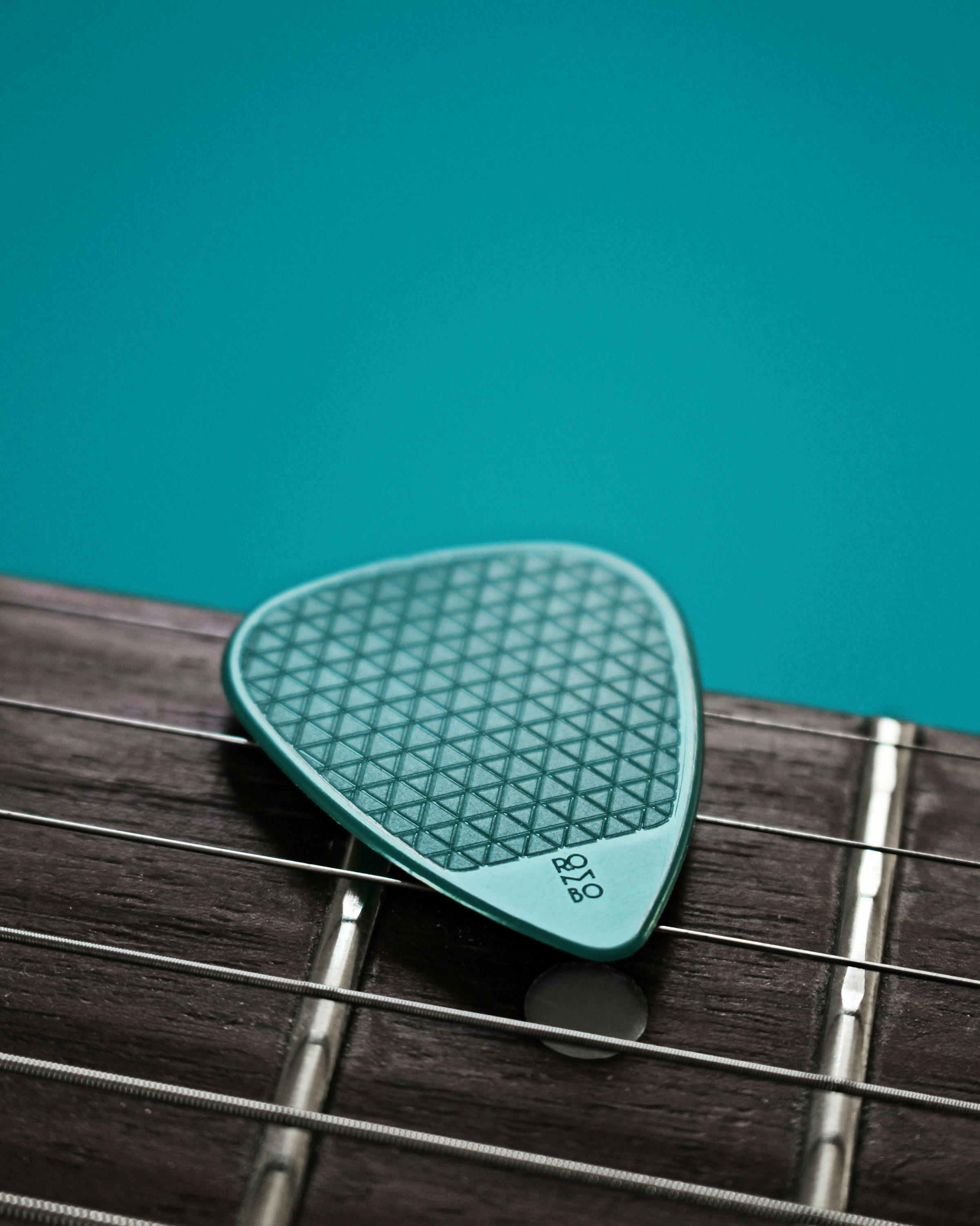 Green Guitar Pick in Close Up Shot · Free Stock Photo