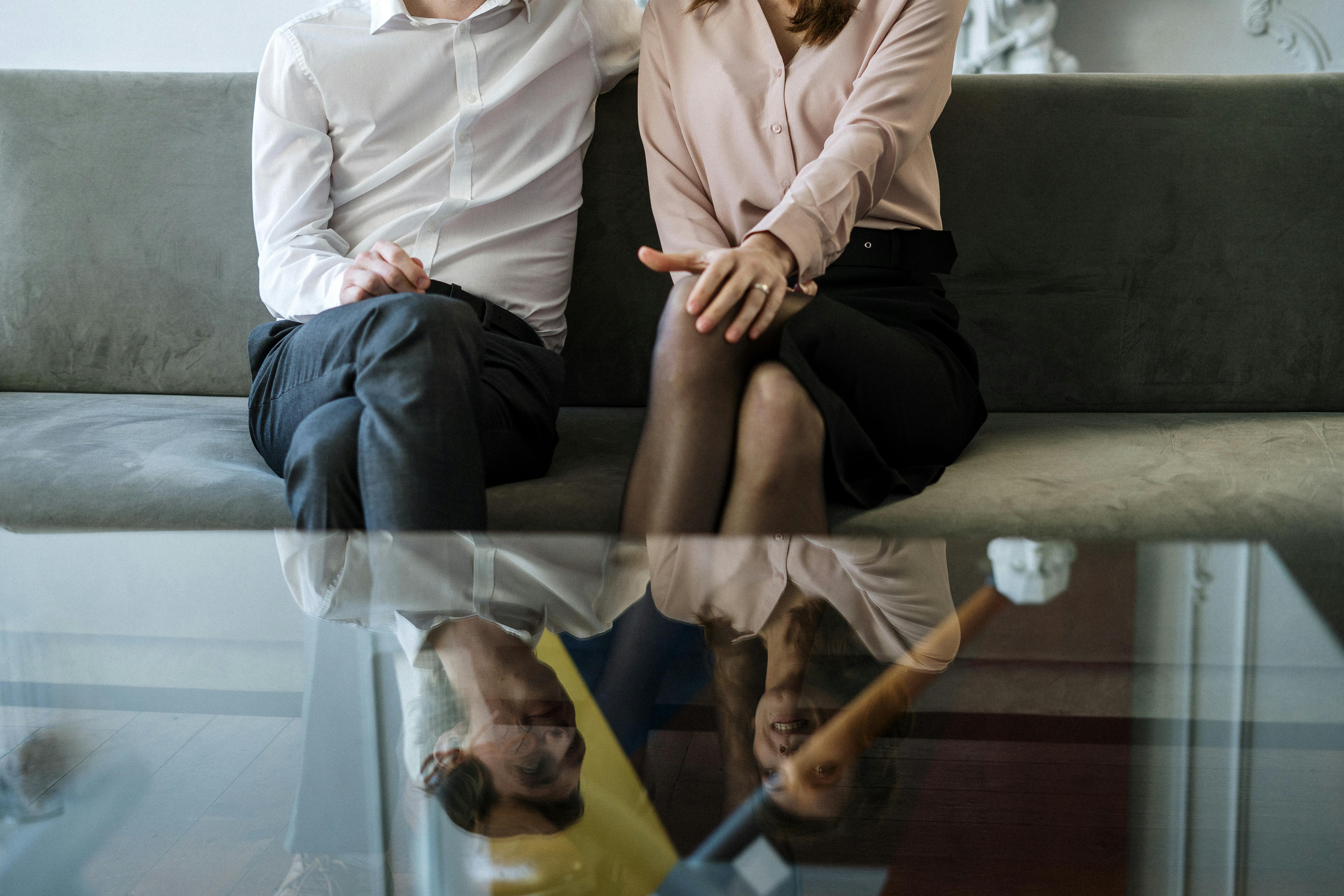 man and woman sitting on couch