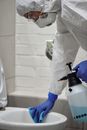 Person in White Dress Shirt Holding White and Blue Plastic Tool