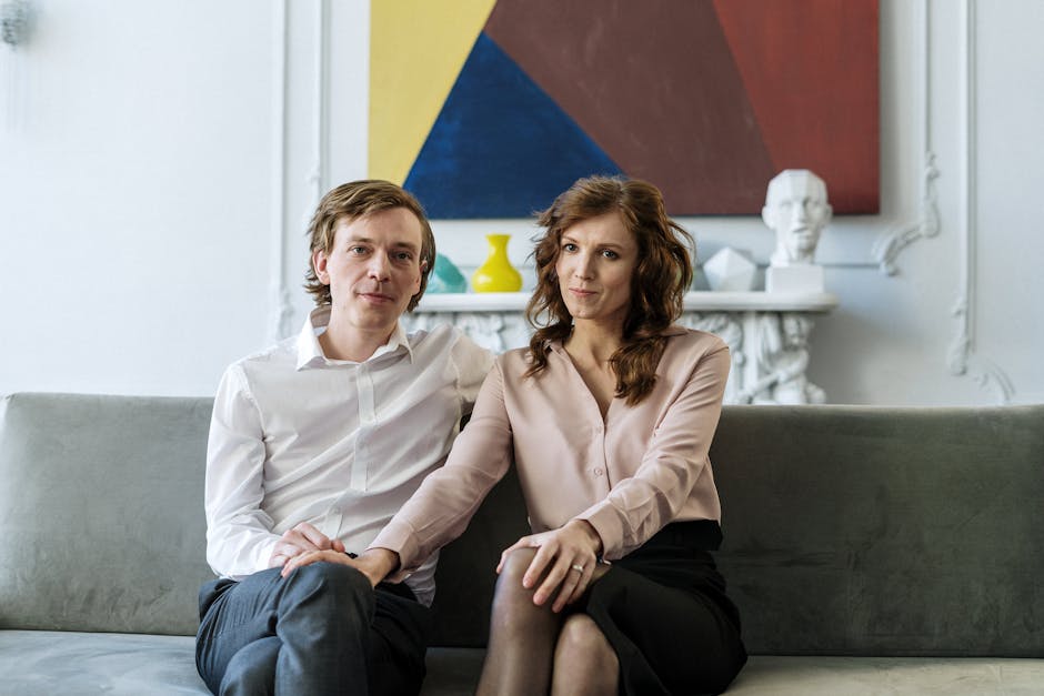 couple talking comfortably on a couch - faith based couples counseling