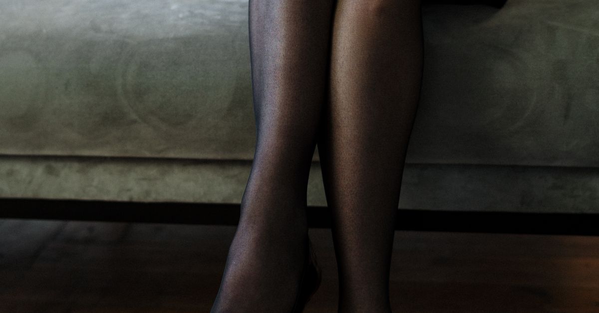 Woman In Black Stockings Sitting On White Couch Free Stock Photo woman-in-black-stockings-sitting-on-white-couch-free-stock-photo