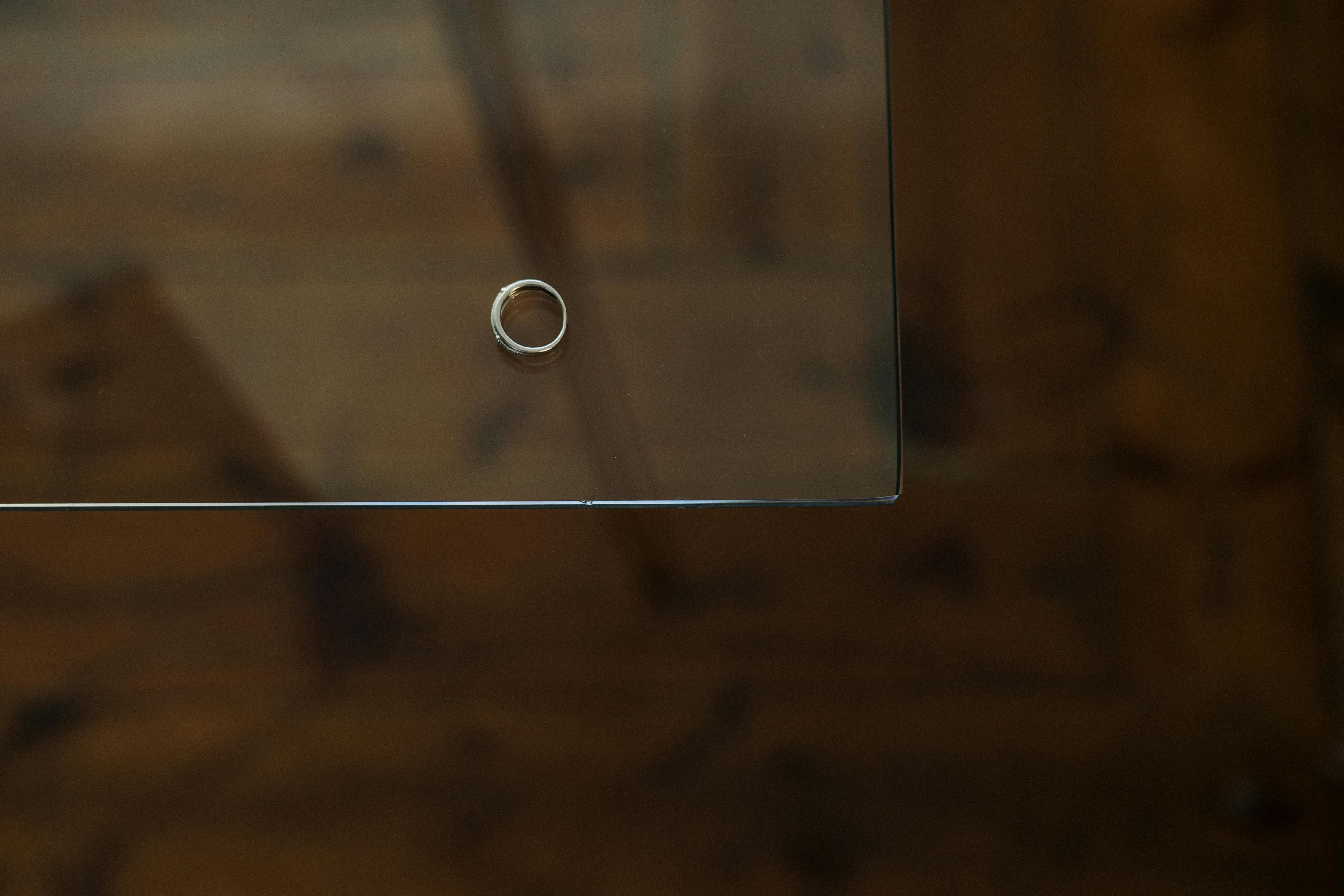 silver ring on brown wooden table