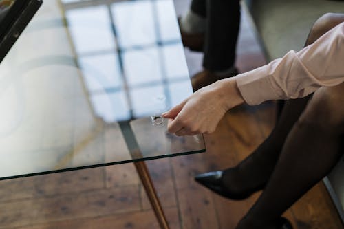 Person in White Long Sleeve Shirt Holding Black Pen