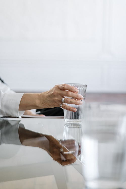 Free Person in White Dress Shirt Holding Clear Drinking Glass Stock Photo