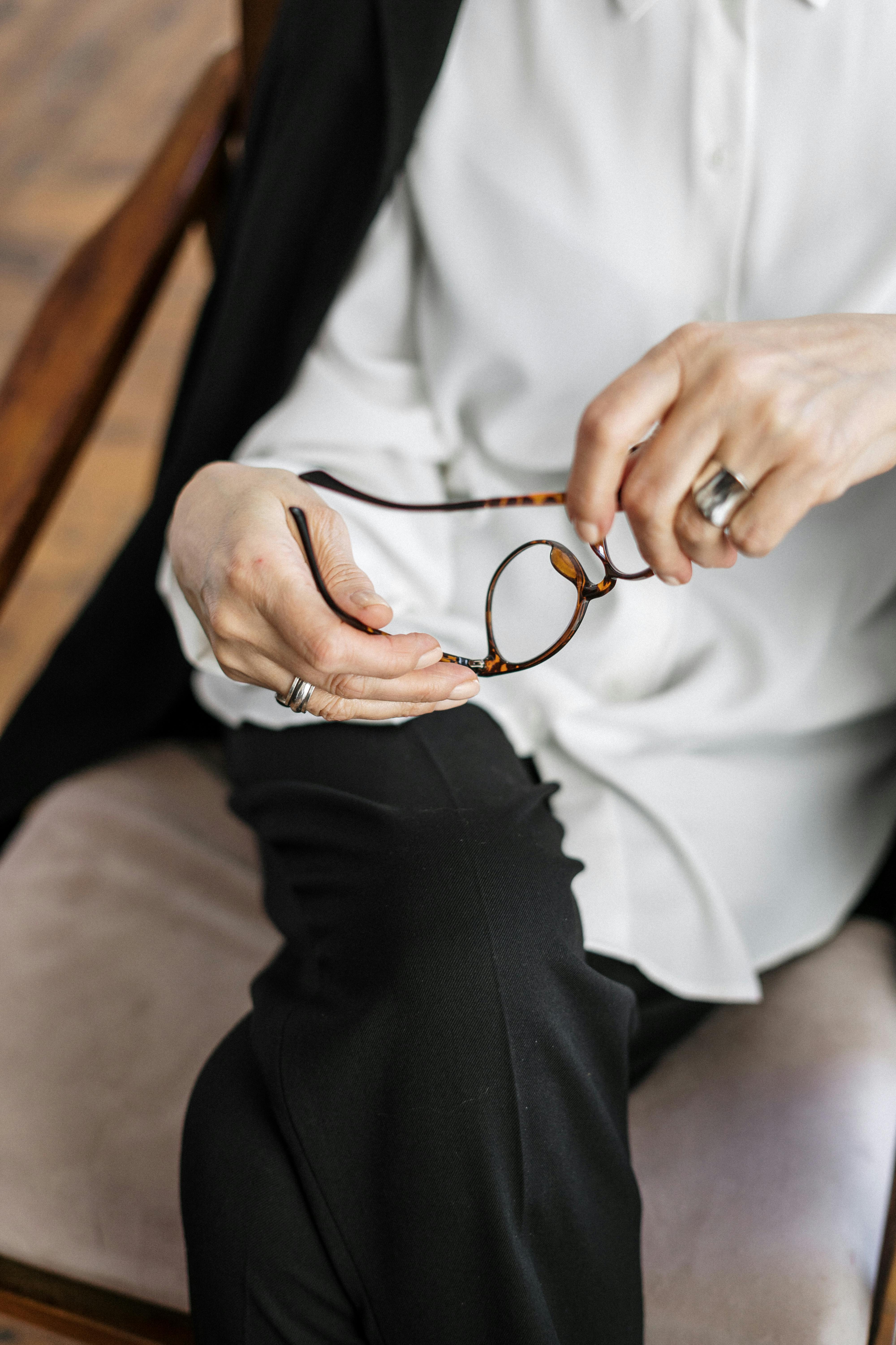 person holding silver and gold ring