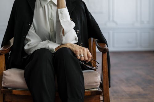 Free Man in Black Suit Sitting on Brown Wooden Armchair Stock Photo
