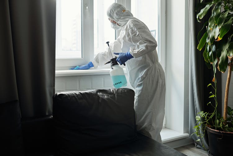 A Person Cleaning The Glass Window