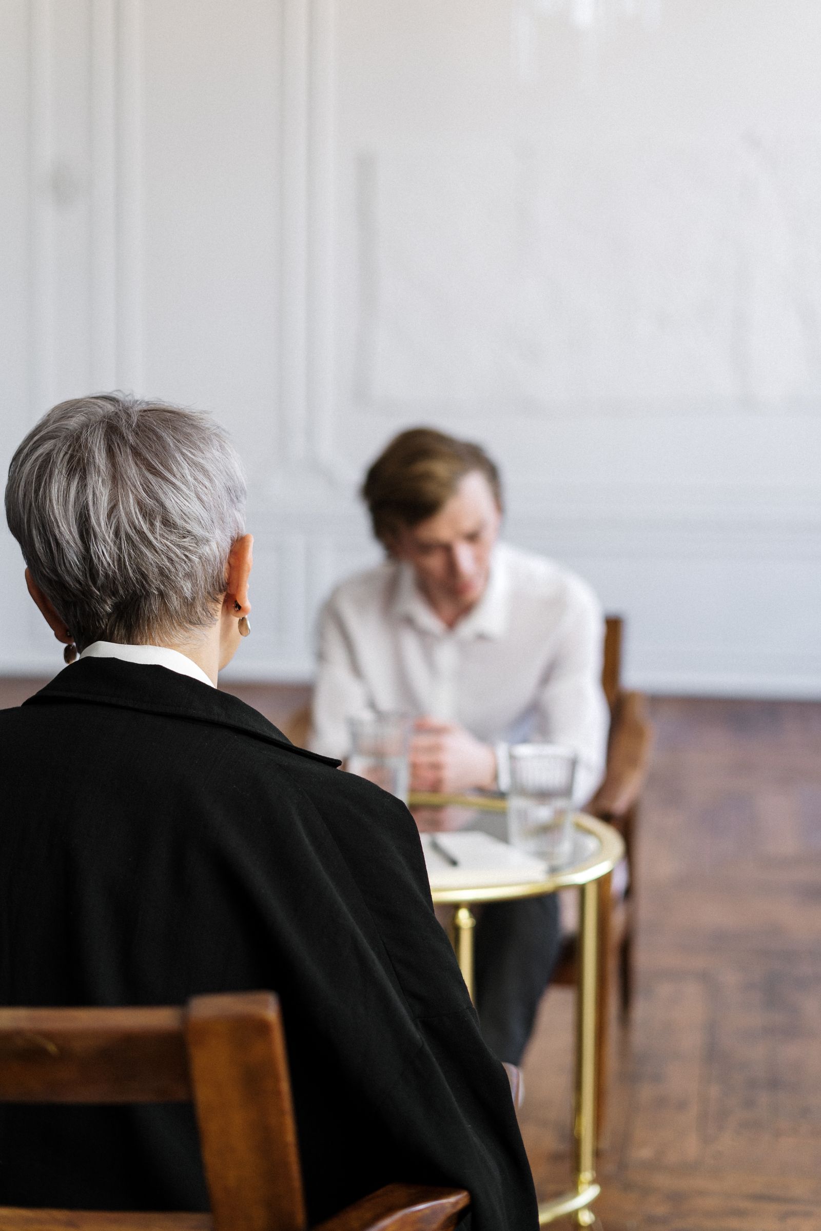 Couple engaged in a therapy session with their counselor in a warm loft office