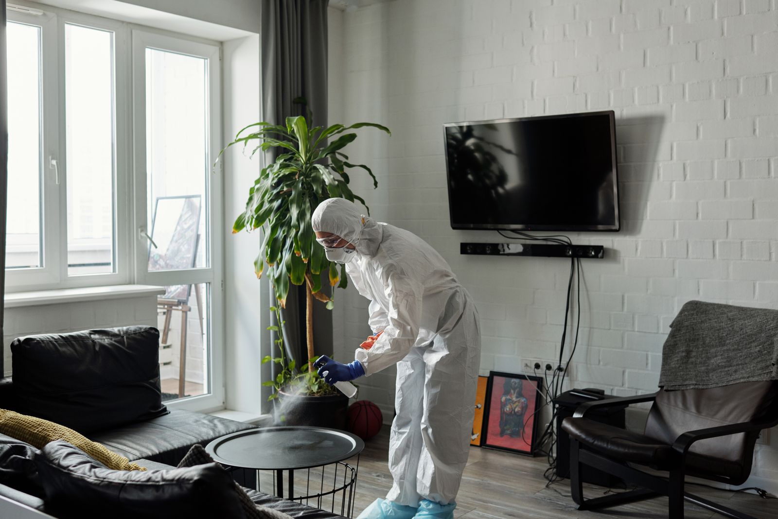 Pest control technician treating a home interior