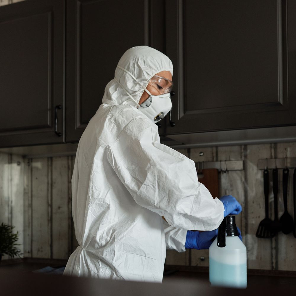 Kitchen Spraying in Woolwich — a decorator at work mid-project