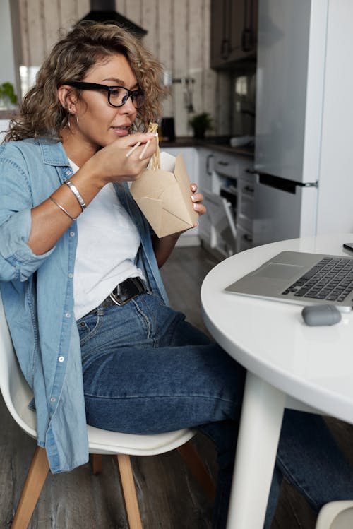 Woman Eating Noodles with Chopsticks