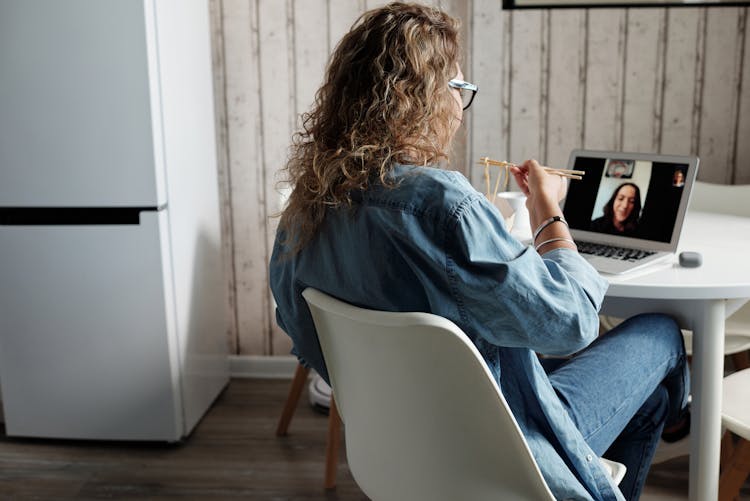 Woman Eating And Talking On Videocall