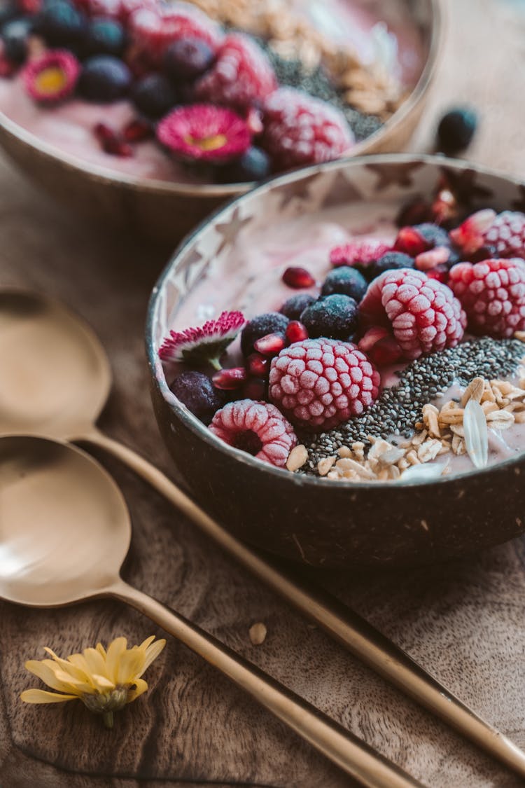 Close Up Of Breakfast Bowls With Fruits And Grains