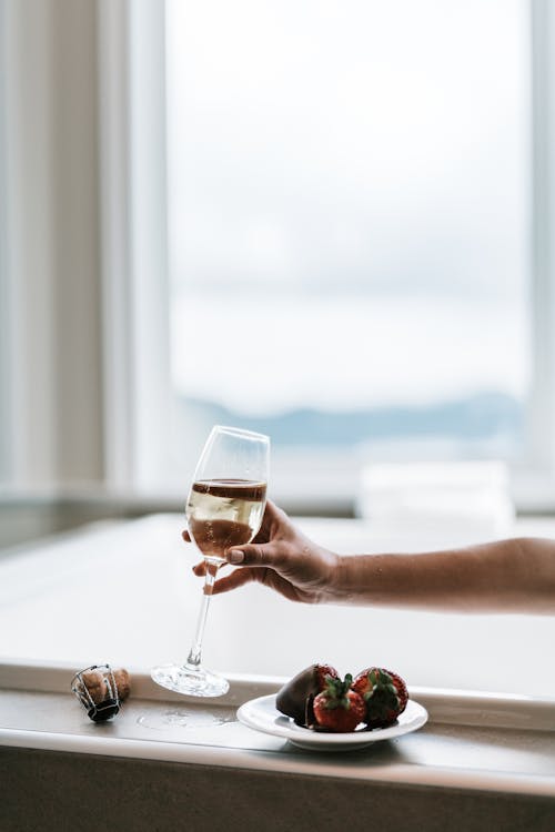 Person Holding Clear Wine Glass