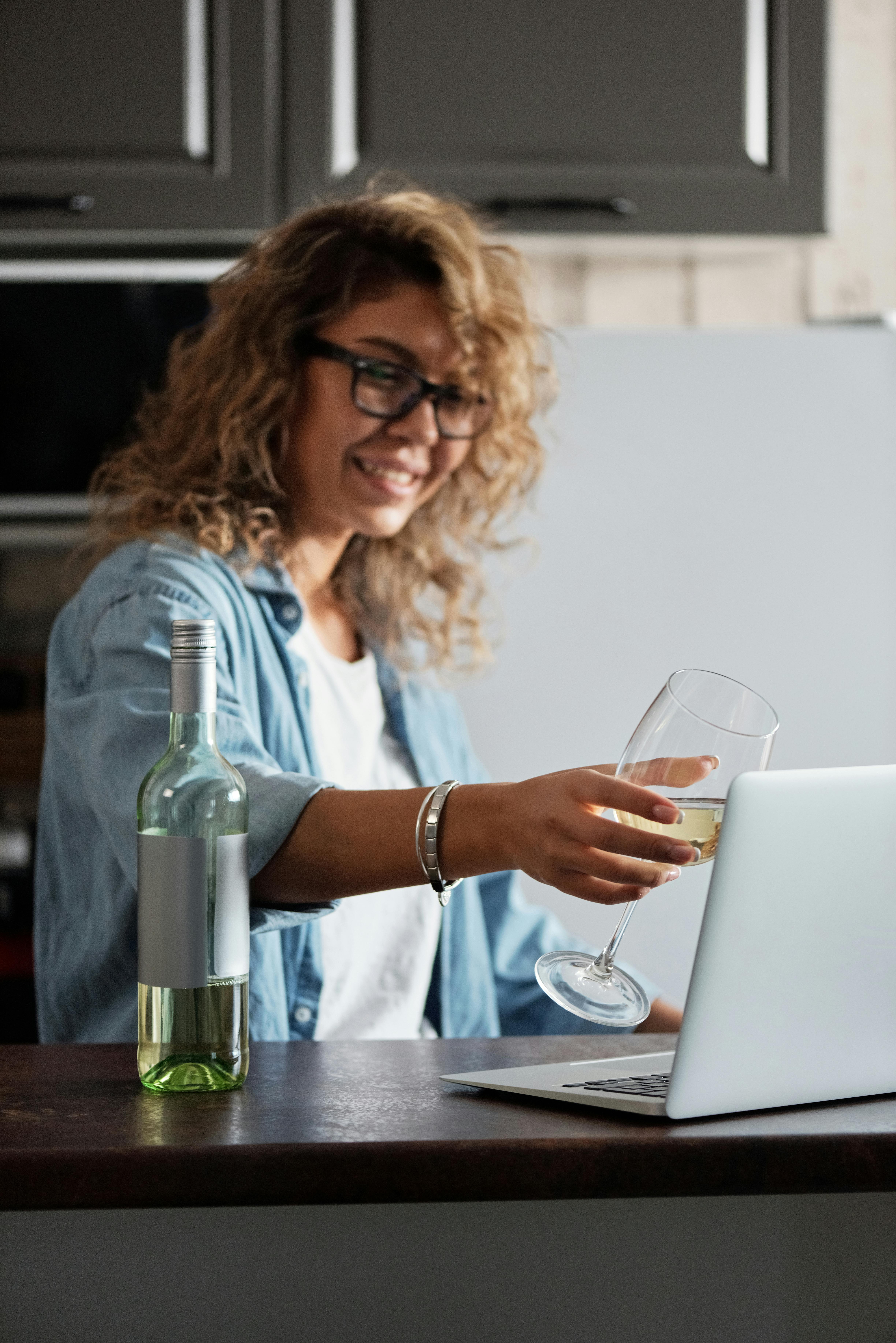 photo of woman holding wine glass