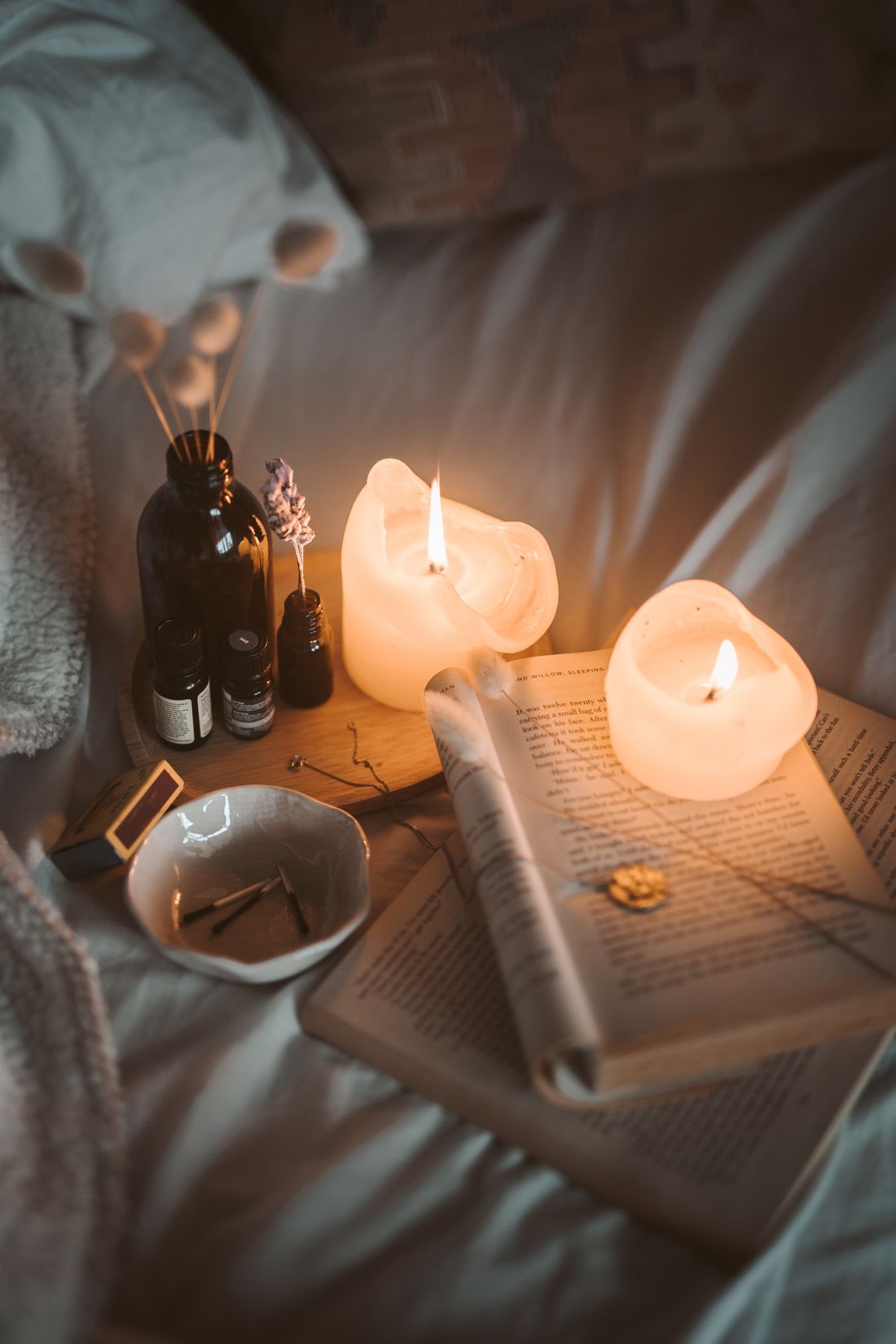 Candles, oils and lavender in soft light