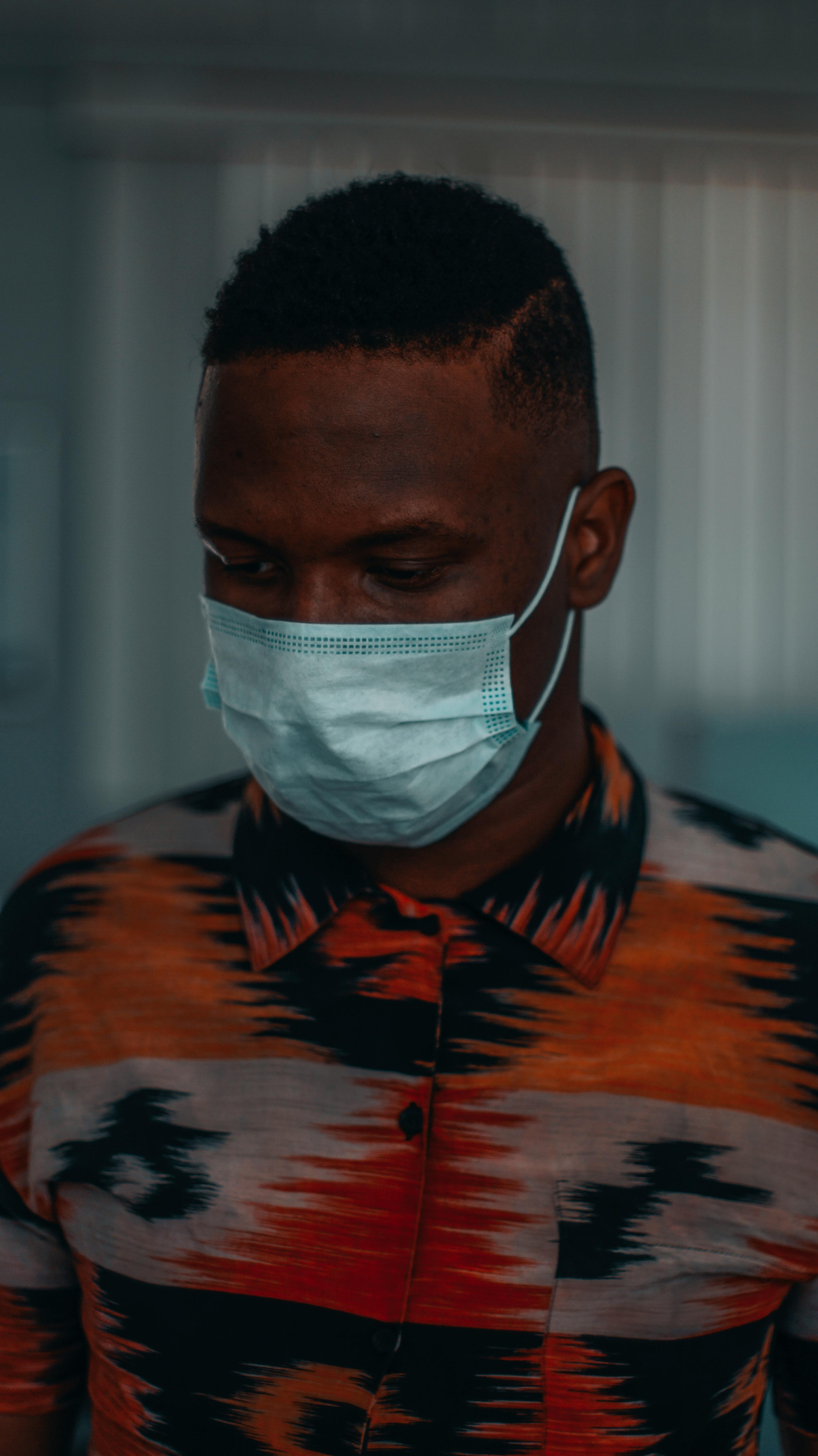 Man in Orange White and Black Stripe Crew Neck Shirt Wearing White Face Mask · Free Stock Photo