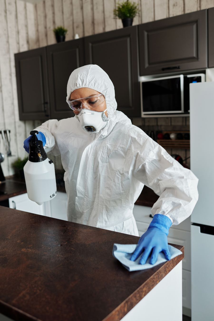 Professional sanitizing and disinfecting a surface